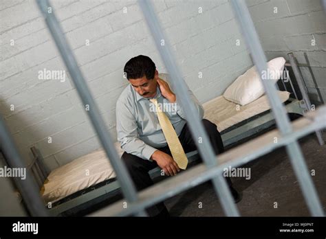 Criminal Sitting On Bed In Jail Stock Photo Alamy