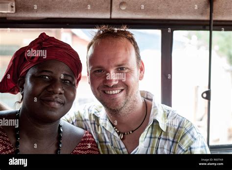 Mali Africa White Caucasian Mature Man Portrait With A Black African Mature Woman Inside A Bus