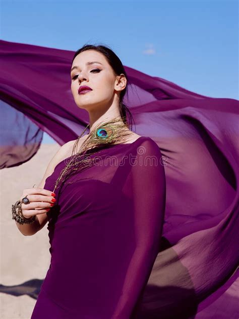 Amazing Beautiful Brunette Woman With The Peacock Feather In Purple