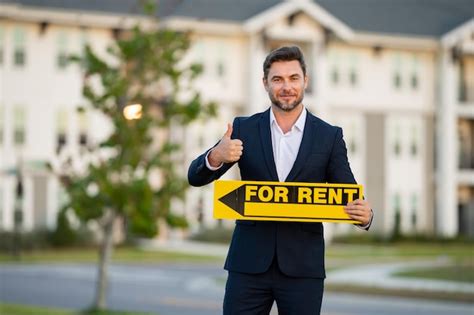 Premium Photo Handsome Real Estate Agent Holding Banner House For