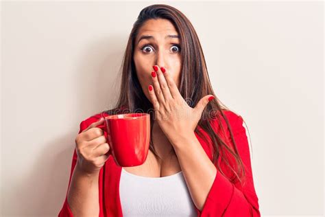 Young Beautiful Brunette Woman Drinking Mug Of Coffee Covering Mouth