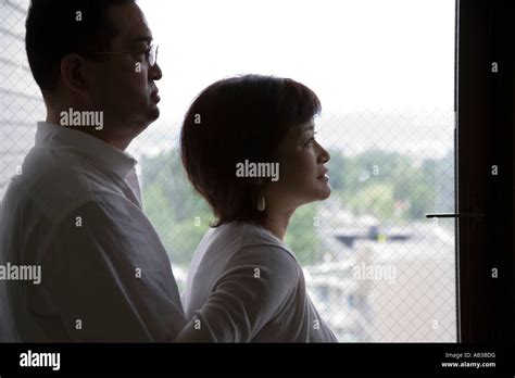 Mature Couple Looking Outside From Balcony Stock Photo Alamy