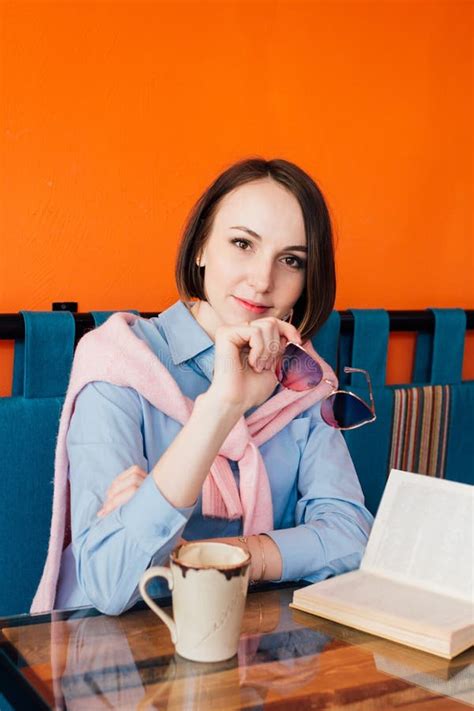 Woman Drinking Coffee and Reading a Book in a Cafe Stock Image - Image ...