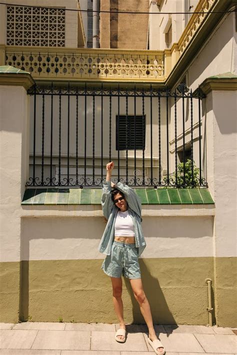 In Full Length Positive Young Caucasian Woman In Sunglasses Stretches