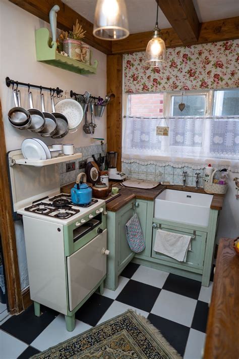 Retro Kitchen with Green Cabinets and Checkered Flooring