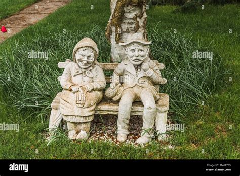 Statue Of Old Man And Woman In The Yard Of The House Stock Photo Alamy