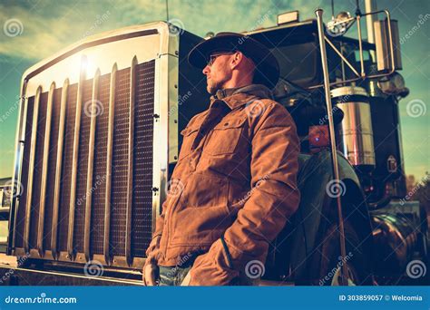 Semi Truck Cowboy Driver Enjoying Scenic Sunset Next To His Vehicle