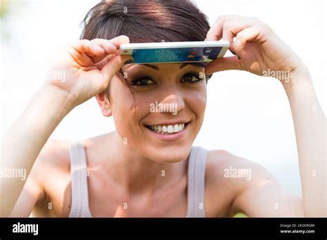 Woman Smiling And Protecting From The Sun Stock Photo Alamy