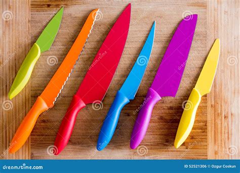 Colorful Kitchen Knives On Wooden Cutting Board Stock Photo Image Of