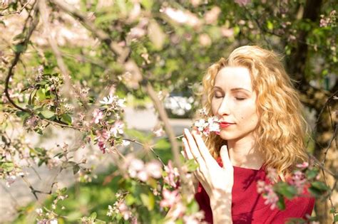 Premium Photo Girl The Blonde Girl Near Cherry Blossoms It S Spring Cherry Blossoms The