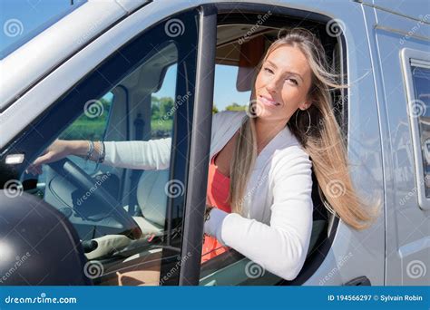 Pretty Happy Smiling Blonde Woman Driving Van Or Modern Campervan In