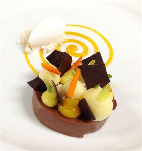 A White Plate Topped With Chocolate And Fruit