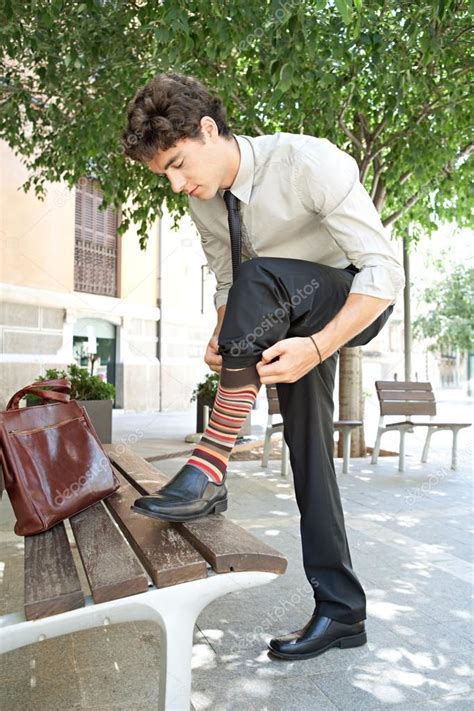 Businessman Pulling Up His Socks — Stock Photo © Mjth 42605889