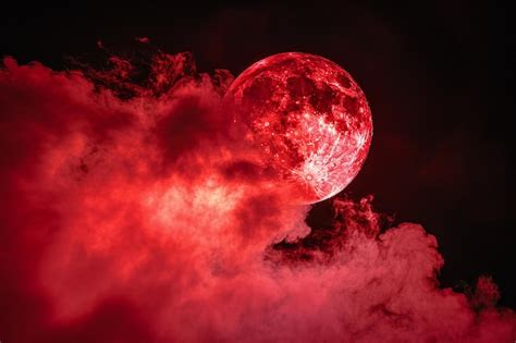 A Red Moon With Pink Smoke On A Black Background In The Concept Of Copy