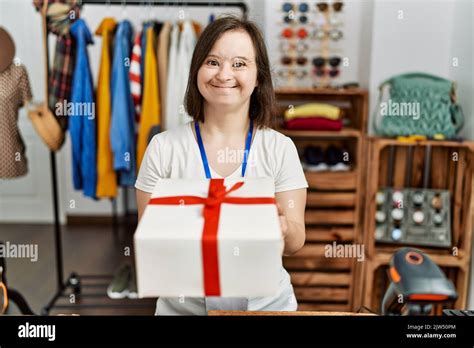 Brunette Woman With Down Syndrome Working As Shop Assistant Wrapping