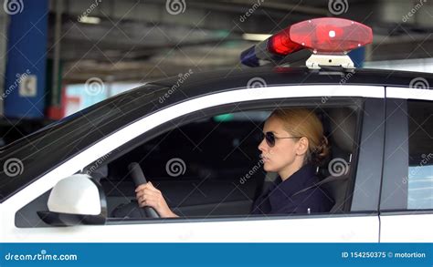 Female Cop Driving Police Car In Underground Parking Patrolling Law