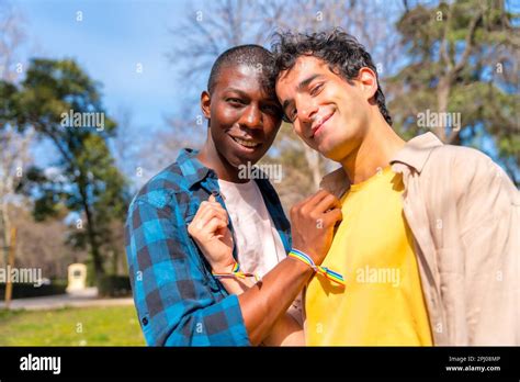 Portrait Of Multiethnic Gay Male Couple On A Romantic Walk In The Park