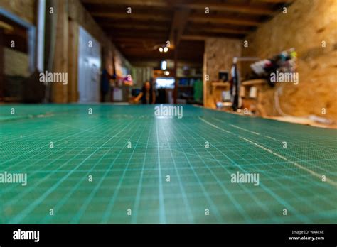 A Closeup View On The Green Grid Cutting Surface On A Technical Drawing