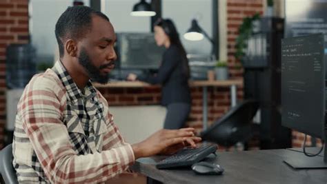 Static Portrait Of African American System Engineer Working Focused