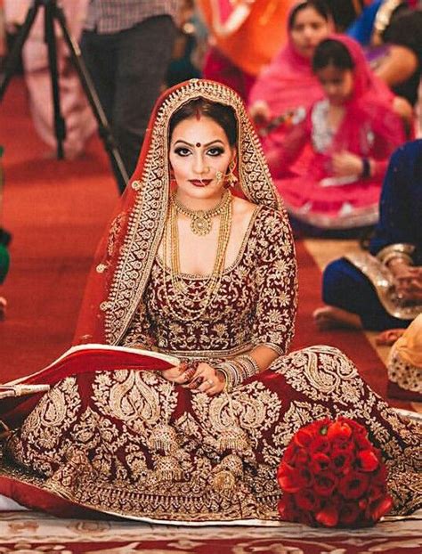 A Bride Sitting On The Floor In Her Bridal Gown And Makeup Looks Like