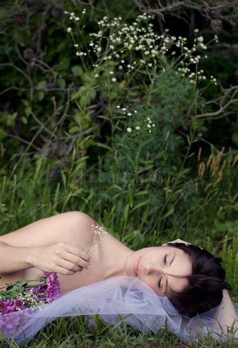 Beautiful Implied Nude Woman In Grass With Flowers Stock Photo Image