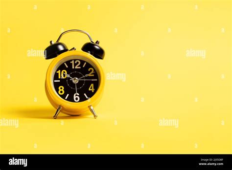 Yellow Alarm Clock On A Yellow Background Stock Photo Alamy