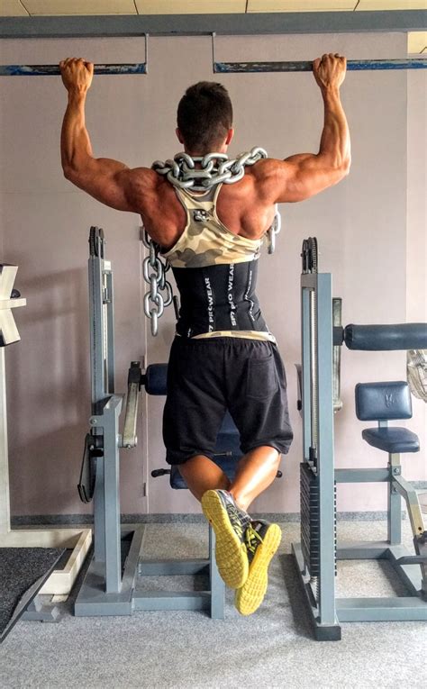 Muscular Man Doing Weighted Pull Ups Exercise High Quality Free Stock