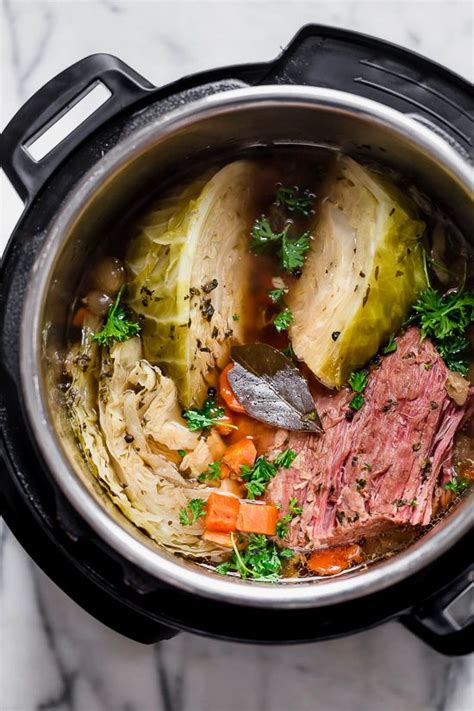 A Pot Filled With Meat And Vegetables On Top Of A Table