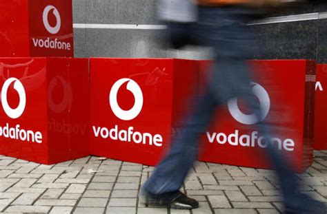 shareholders poised  oppose vodafone pay report  dividend row