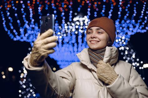 Premium Photo Happy Woman In Warm Clothes Taking Selfie On Mobile