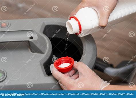 Cleaner Pours Chemicals into the Extractor Machine for Dry Cleaning by ...