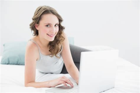 Premium Photo Smiling Casual Brunette With Laptop In Bed