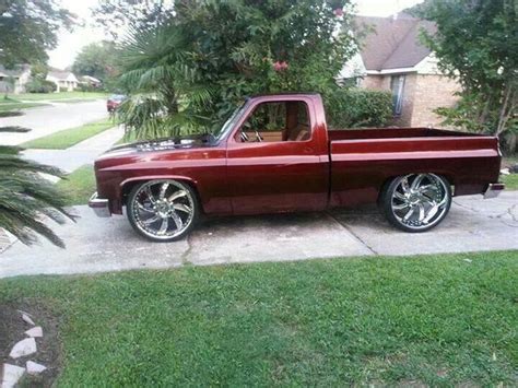 A Red Pick Up Truck Parked In Front Of A House