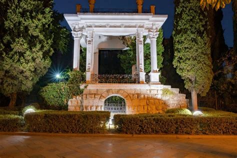 Garden Gazebo In The Greek Style In The Evening With Artificial