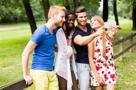 Premium Photo Young Multiracial Friends Taking Selfie In The Park