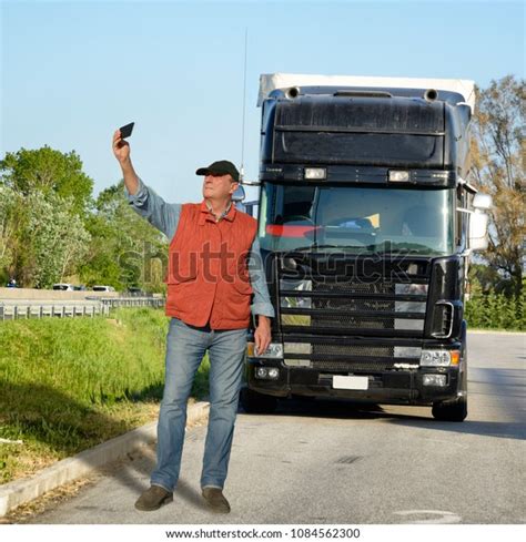 Стоковая фотография 1084562300 Truck Driver Having Selfie Truck