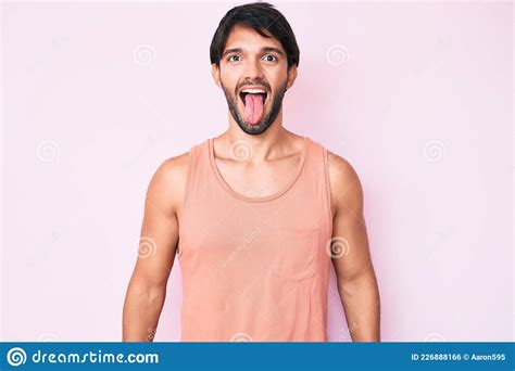 Handsome Hispanic Man Wearing Casual Clothes Sticking Tongue Out Happy