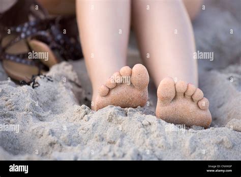 Girls bare feet on a beach Stock Photo - Alamy