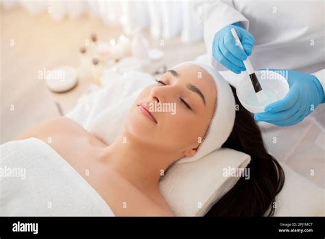 Relaxed Indian Woman Getting Skin Treatment At Modern Spa Salon Stock