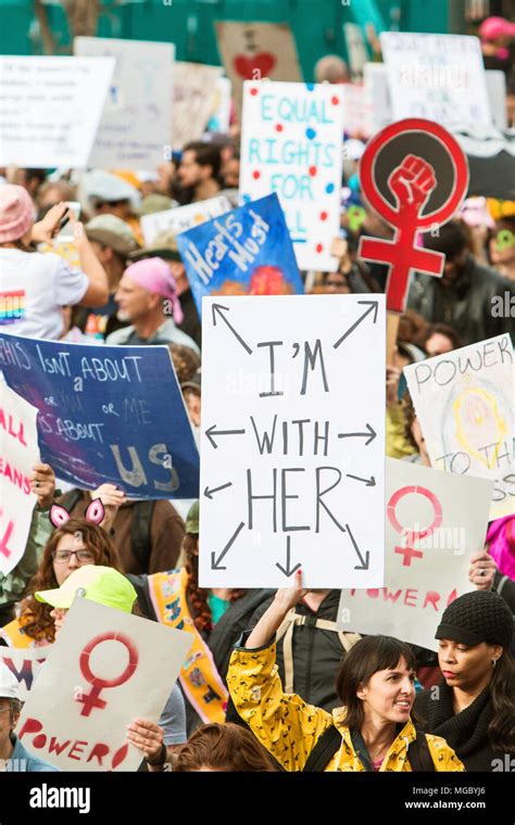 Woman Holds Up Sign That Says Im With Her As She Is Surrounded By