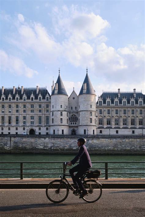 Paris France A Man Riding A Bicycle On Banks Of Seine River In Front