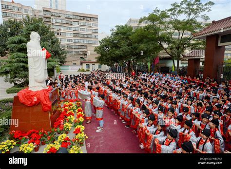 Young Pupils Dressed In Ancient Chinese Student Costumes Bow To The