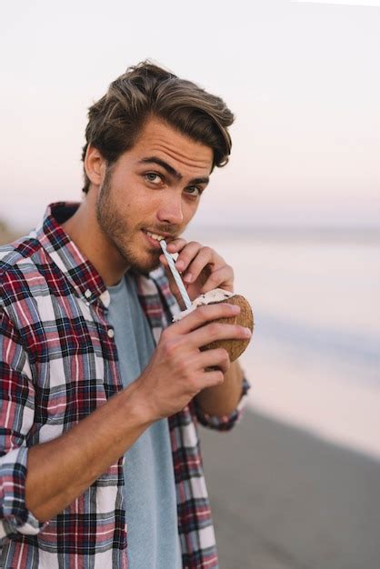 Free Photo Man Drinking Coconut At The Beach