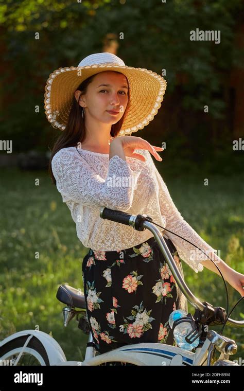 Happy Brunette Girl Posing With Bike At At Sunny Meadow Stock Photo Alamy