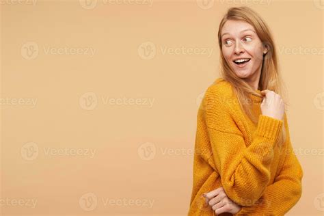 Excited Young Pretty Long Haired Redhead Lady Raising Surprisedly Her Eyebrows While Looking