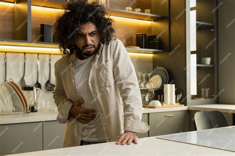 Premium Photo Egyptian Man Suffers From Sudden Pain In Stomach In Kitchen