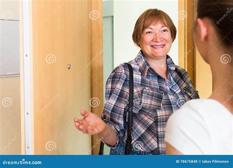 Cheerful Greeting Of Two Women At The Door Stock Photo Image Of