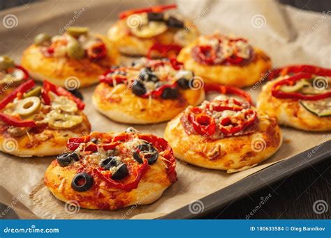 Homemade Mini Pizza With Salami Pepper Olives And Cheese Stock Photo