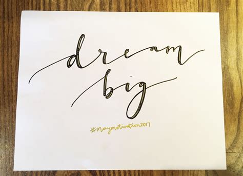 A Piece Of Paper With The Words Dream Big Written On It In Cursive Writing