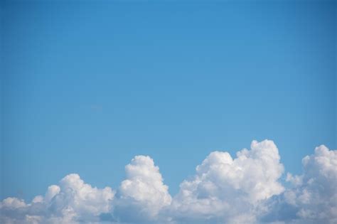 Premium Photo Blue Sky Background With White Fluffy Cumulus Clouds